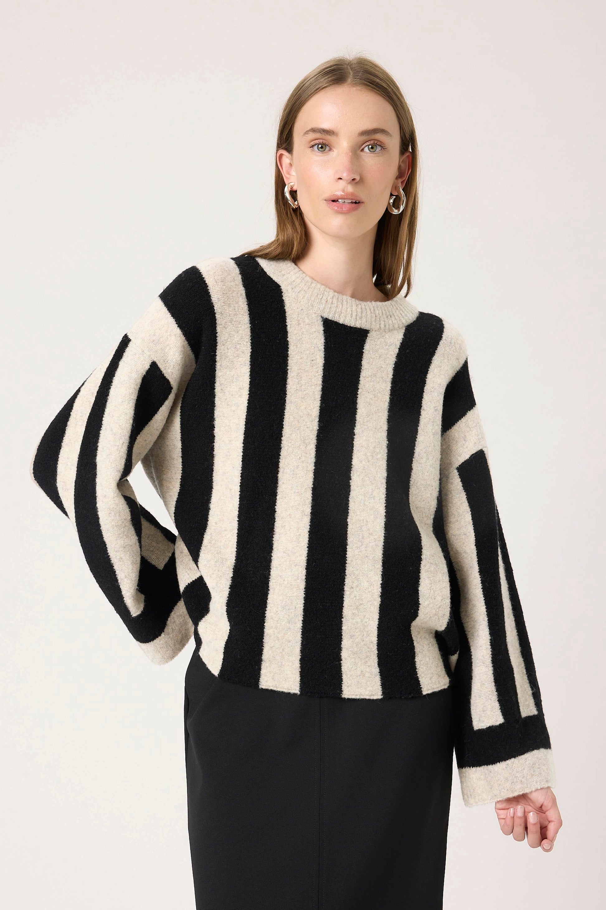 Woman wearing  The soaked in luxury briony black and white striped sweater .
