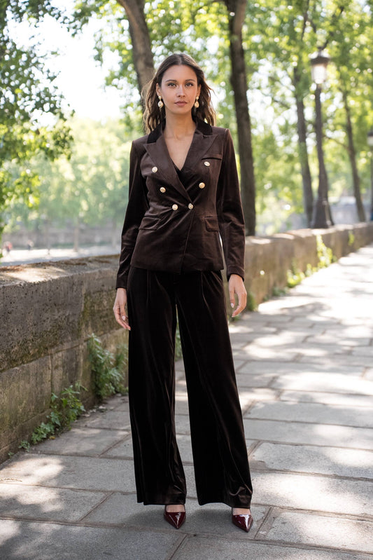 Woman wearing brown straight leg velvet trousers