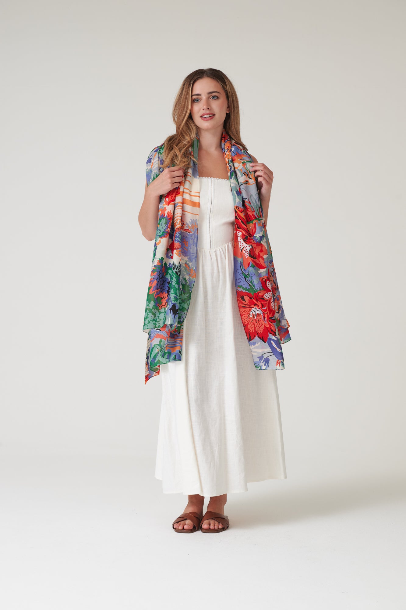 One Hundred Stars Tropicana Blue Scarf featuring a vibrant botanical print in refreshing blue tones.