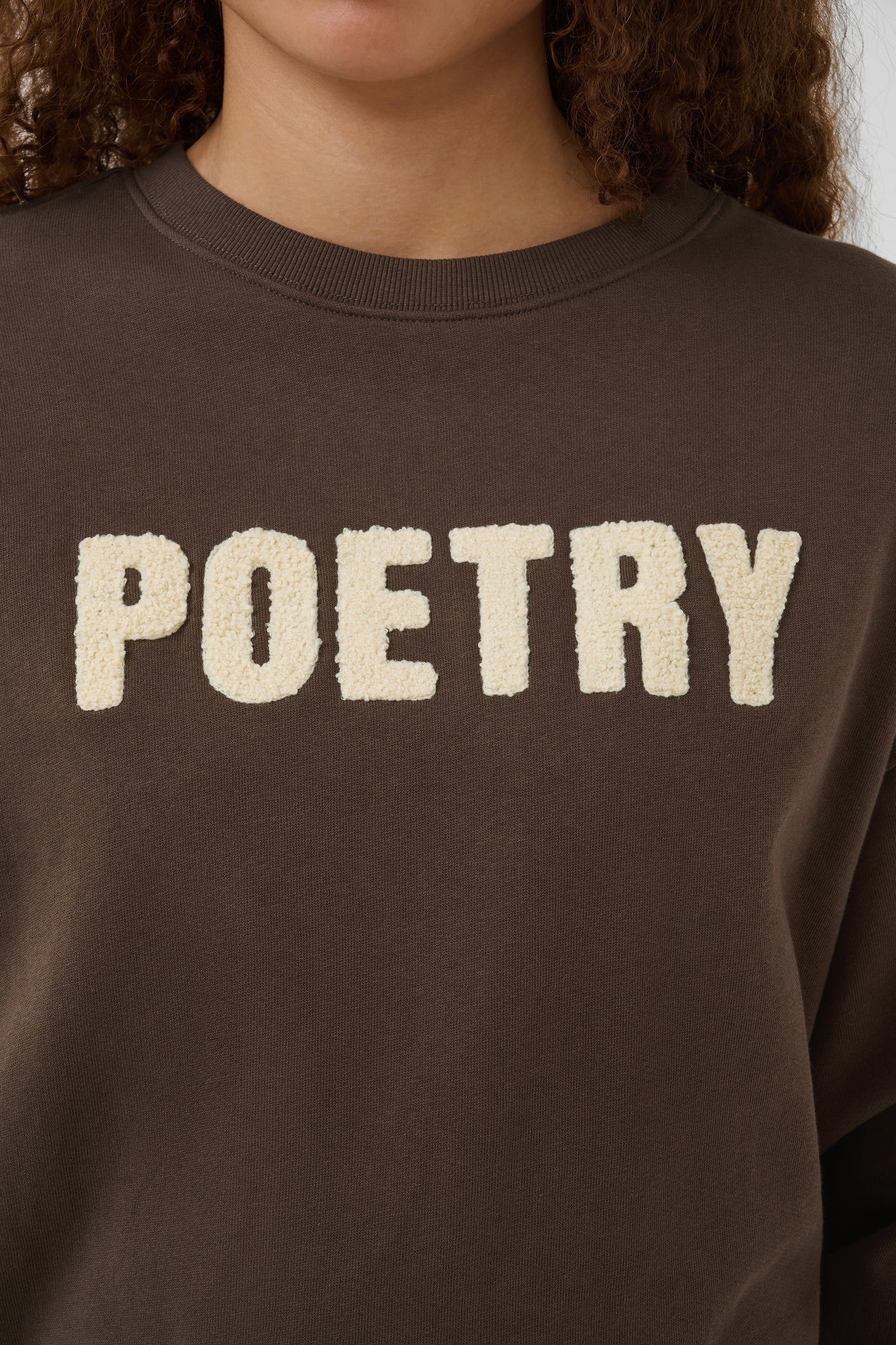 Brown Saint Tropez suzie sweatshirt with the word poetry across the front