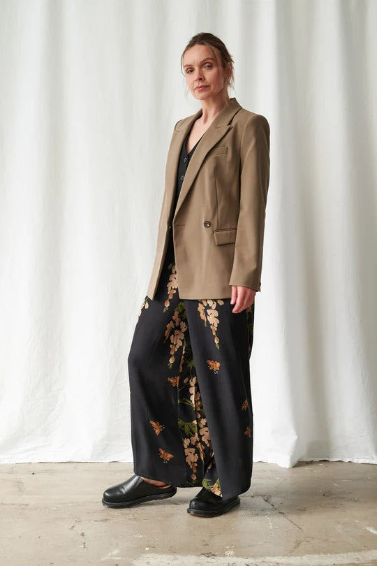 One Hundred Stars Wisteria Black Palazzo Pants featuring a botanical wisteria print on a black background with a flowing wide-leg silhouette