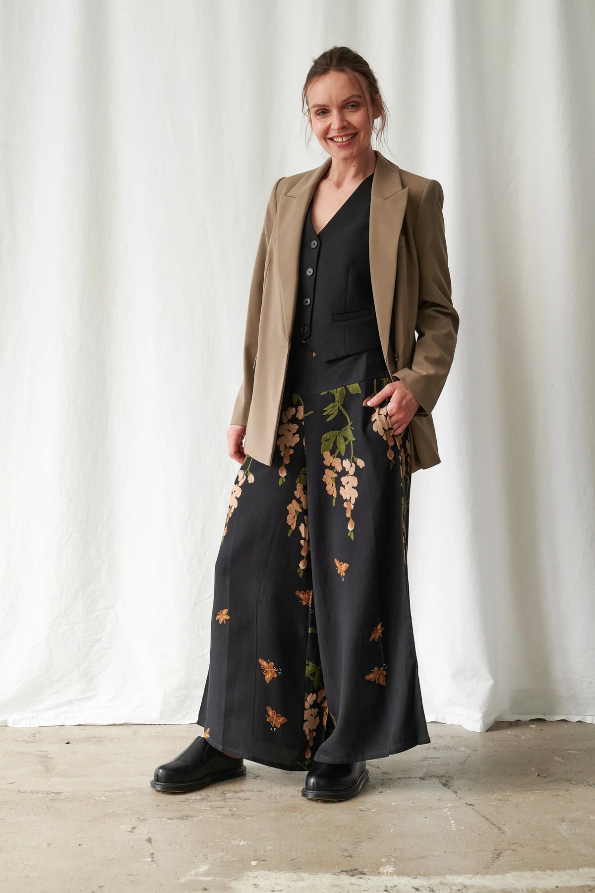 One Hundred Stars Wisteria Black Palazzo Pants featuring a botanical wisteria print on a black background with a flowing wide-leg silhouette