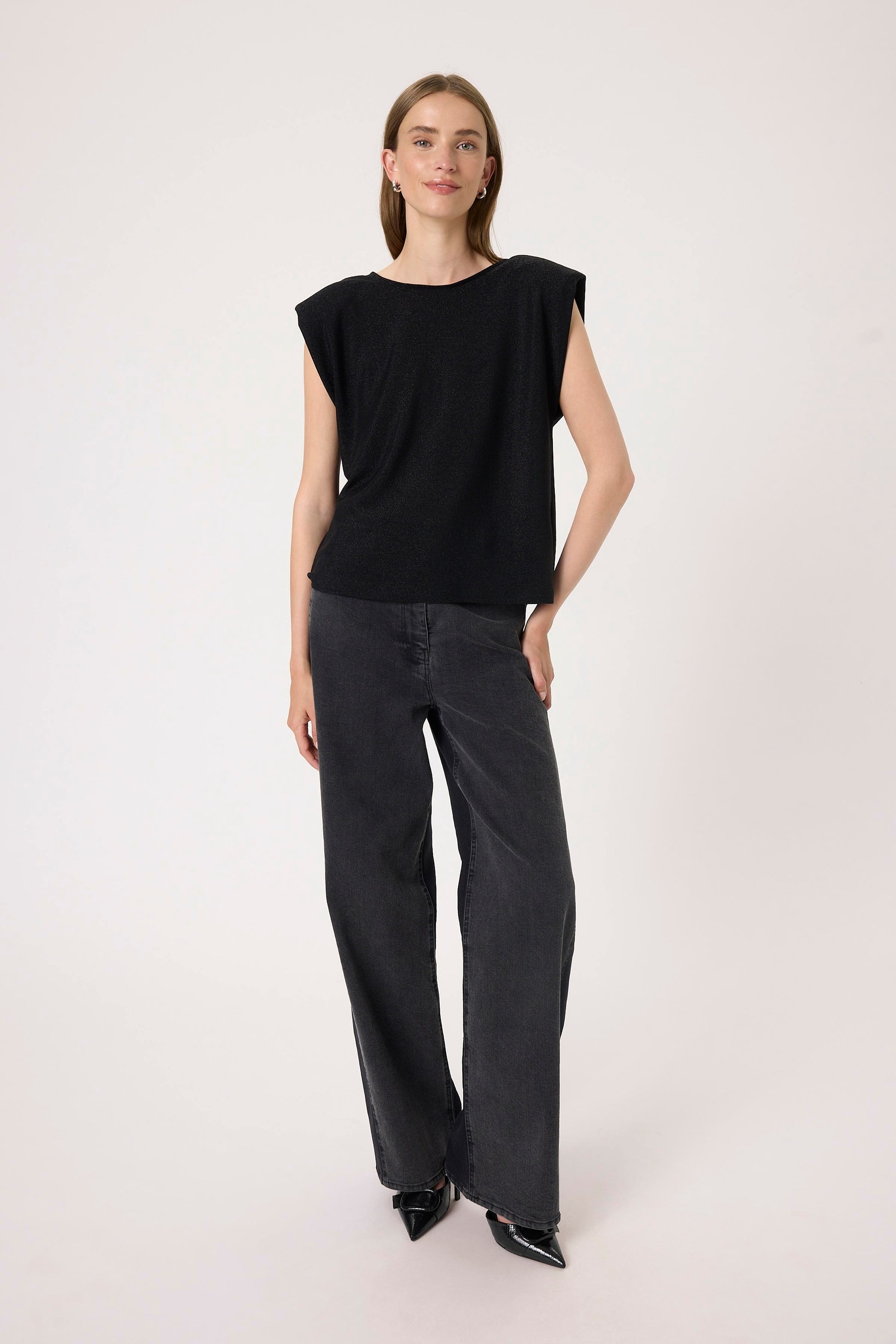 Woman wearing the Soaked in Luxury Skylara Tank top in black with metallic yarn