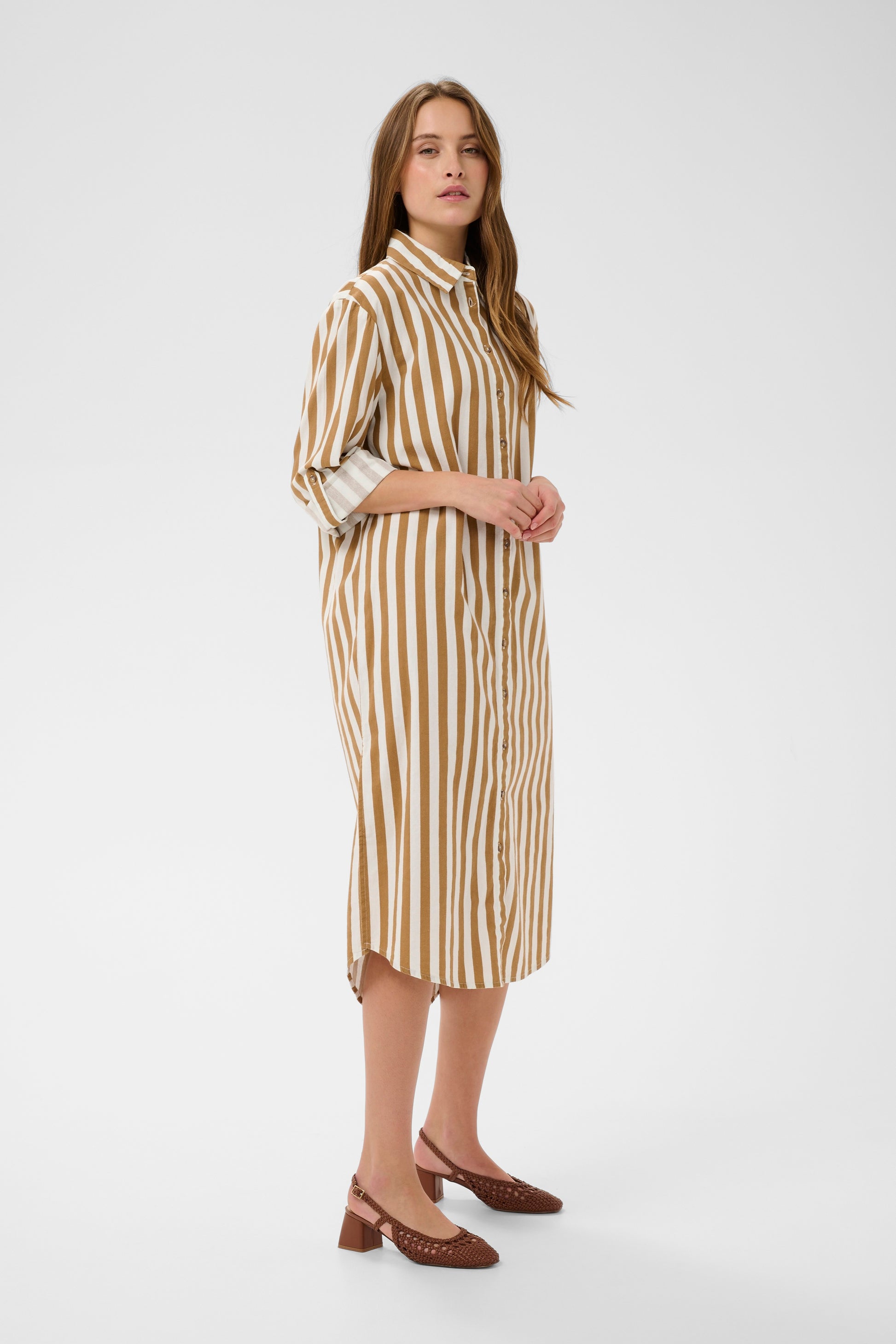 Woman wearing the Zalinda brown and white striped shirt dress 