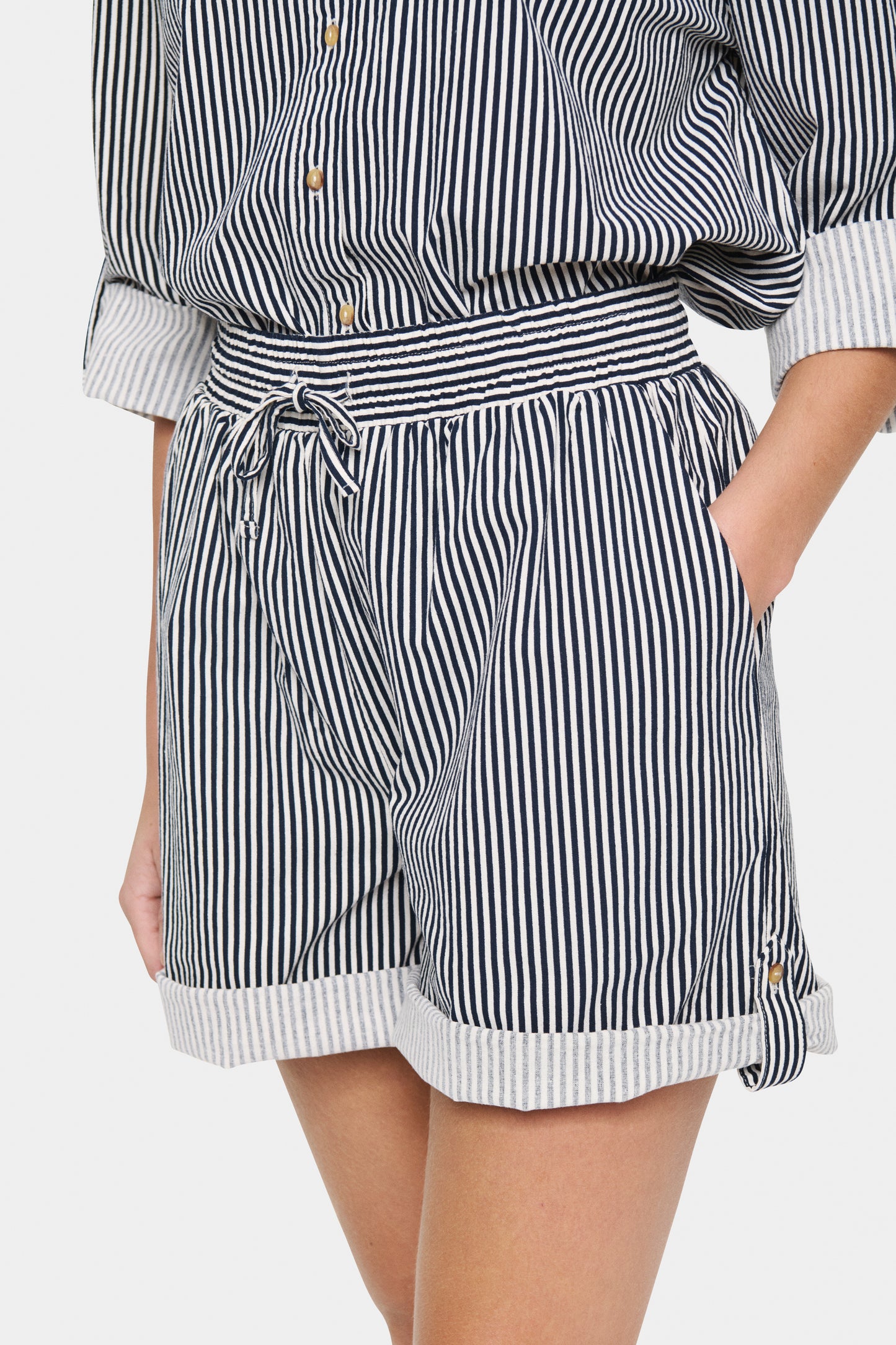 Woman wearing the Saint tropez black and white striped shorts.