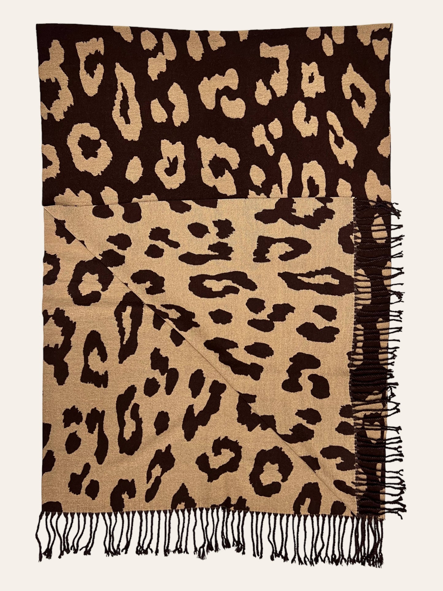 Leopard print scarf with fringes on a plain background