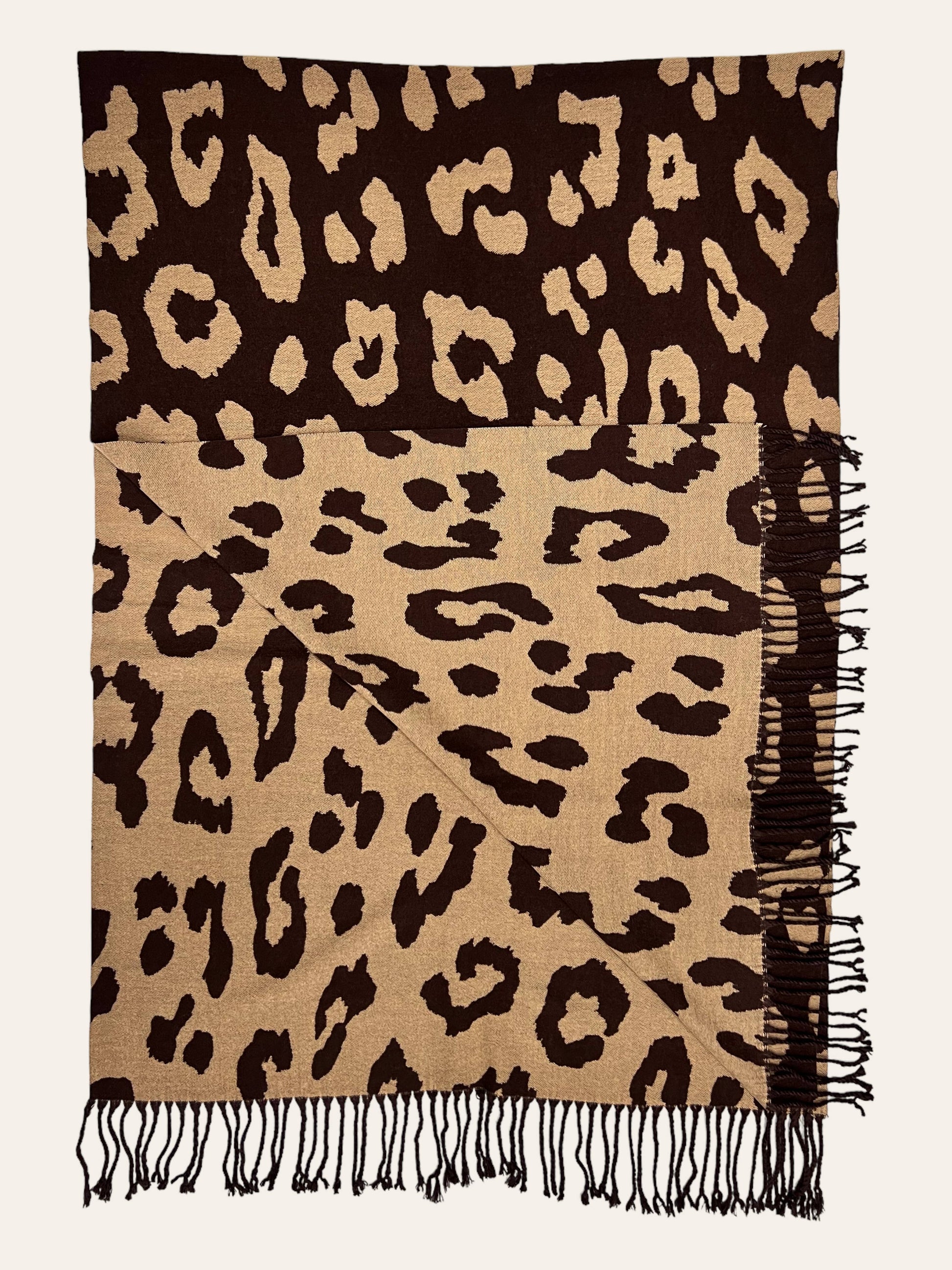 Leopard print scarf with fringes on a plain background