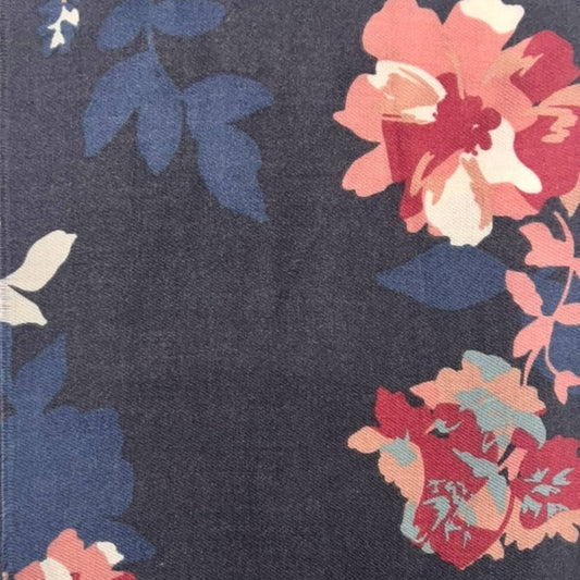 Floral patterned fabric with blue, pink, and red flowers on a dark background