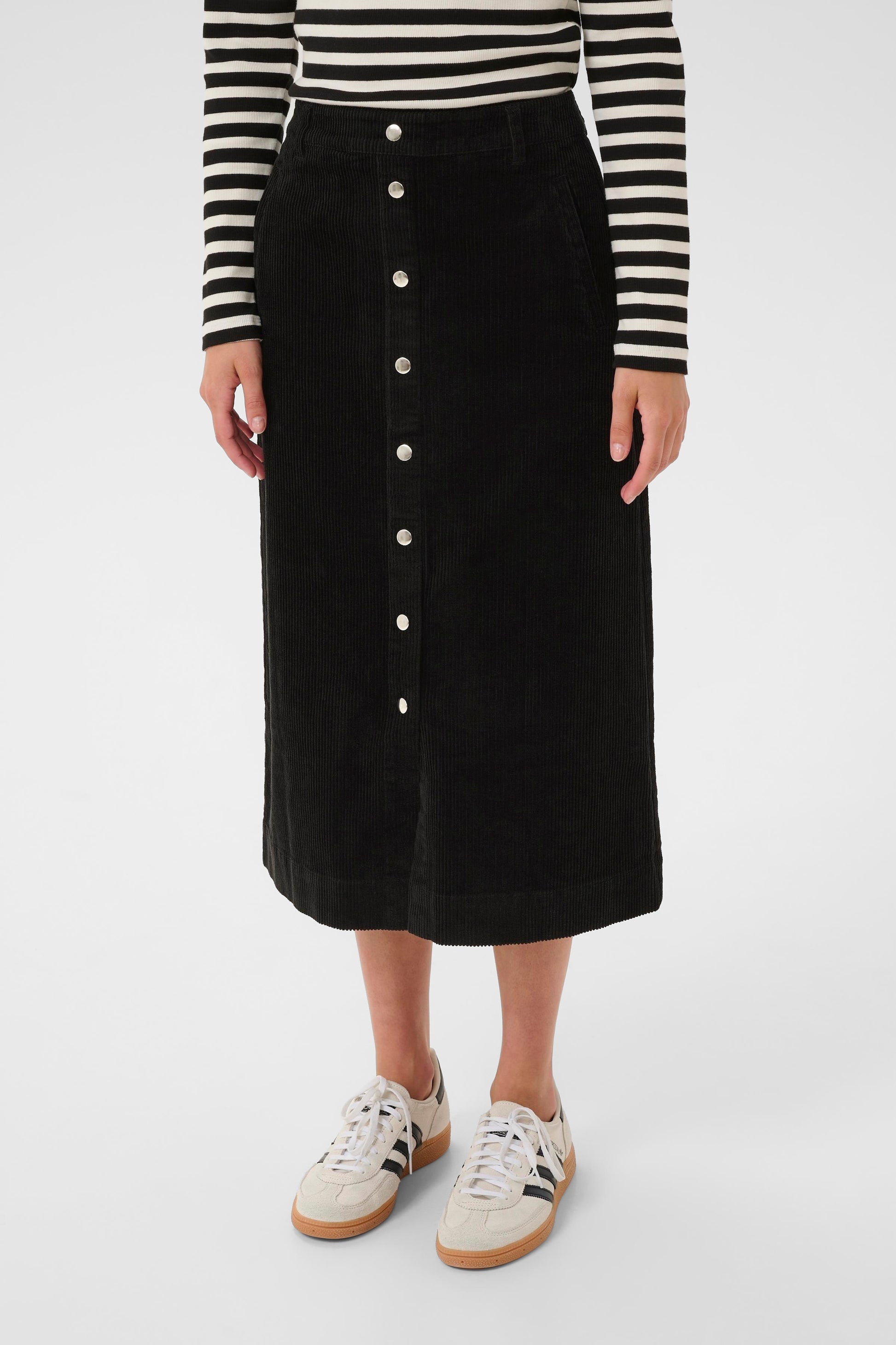 Woman wearing the part two shayla cord brown skirt sweater on a white background close up