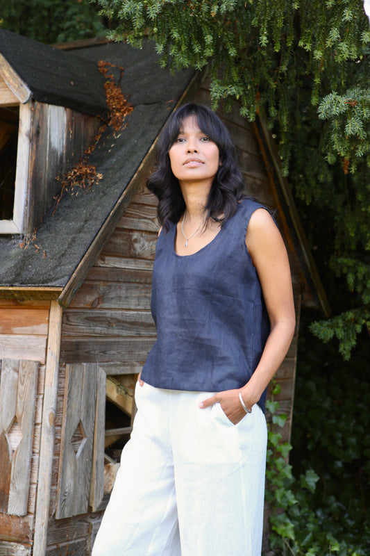 WOman wearing a sleeveless linen top in blue