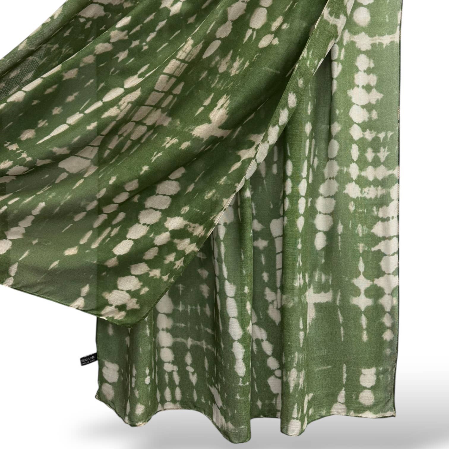 Green and white patterned fabric draped over a surface