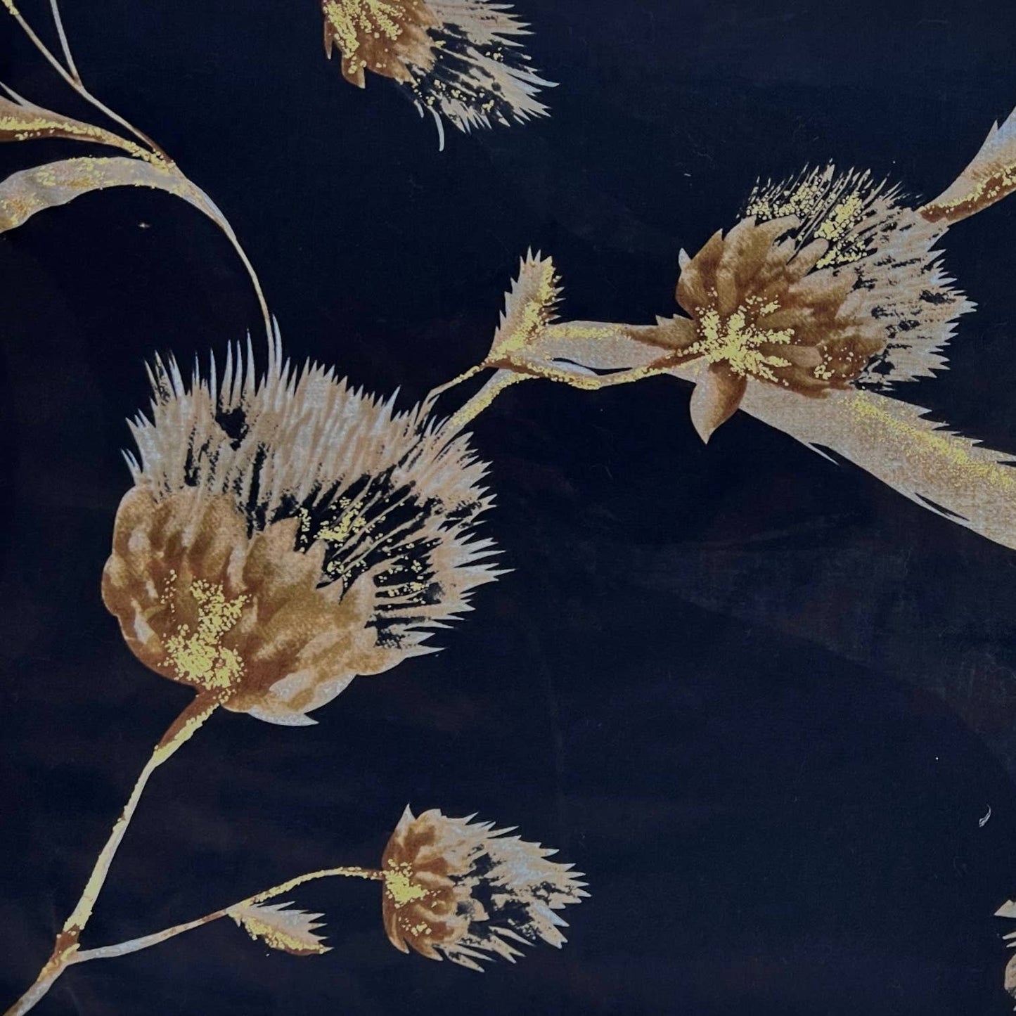 Decorative fabric with beige floral patterns on a dark background