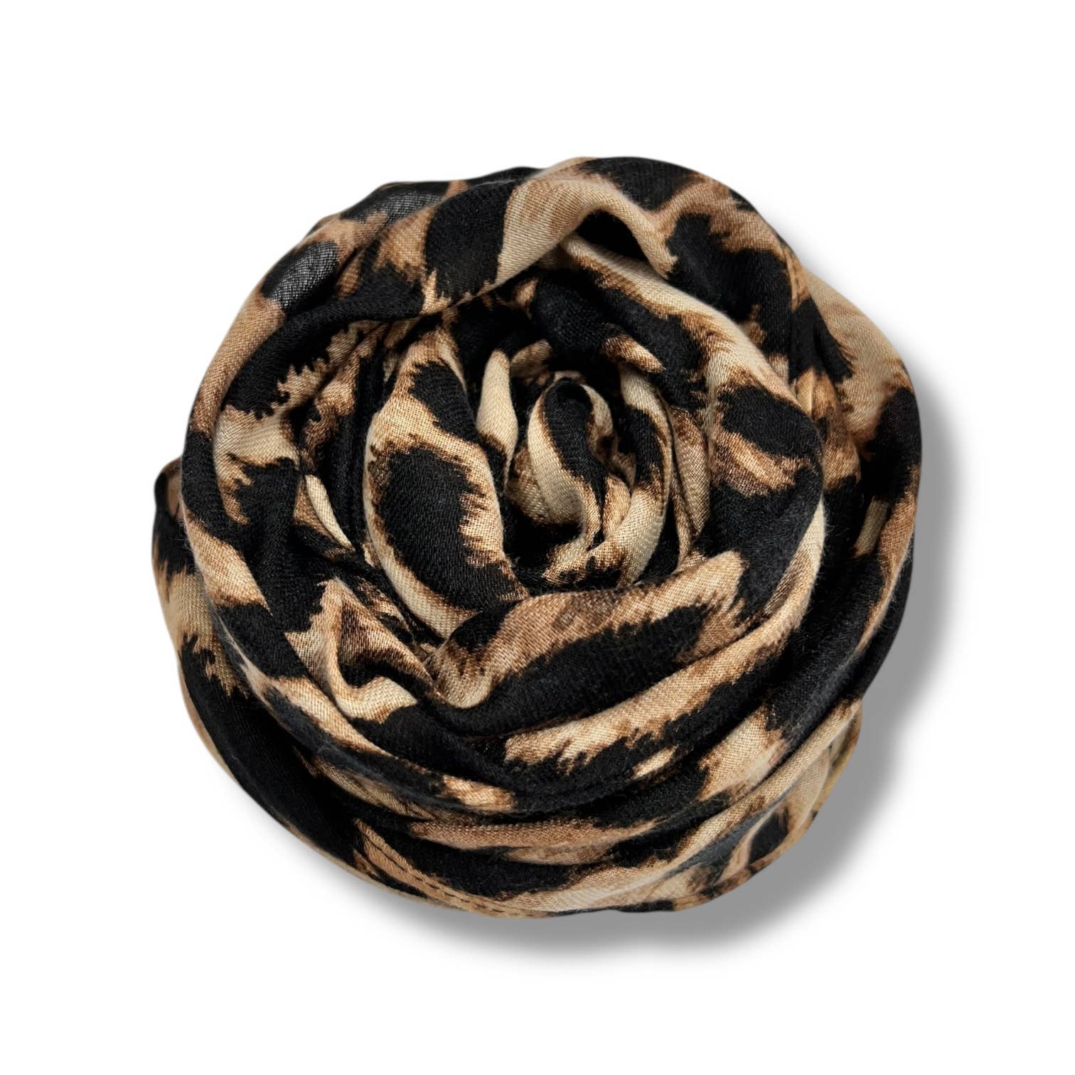 Leopard print scarf rolled up on a white background