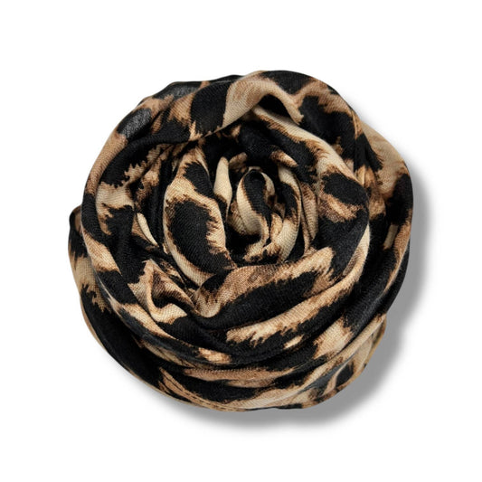 Leopard print scarf rolled up on a white background